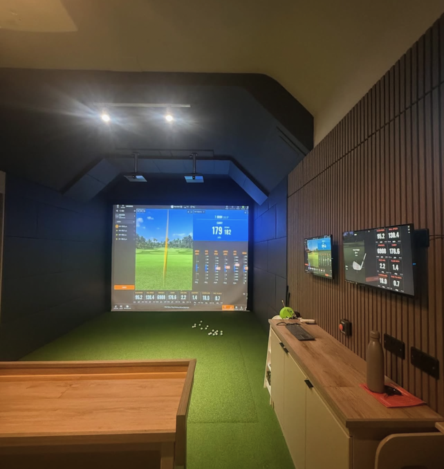 View of the Trackman golf simulator studio at South Staffordshire Golf Club, including data screen to side.